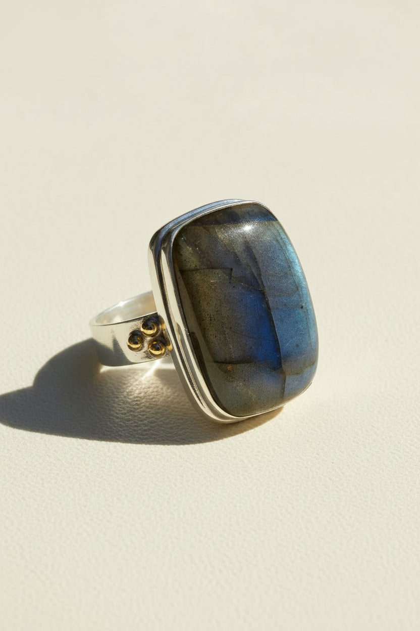 Square blue labradorite ring on a silver band with small brass side details