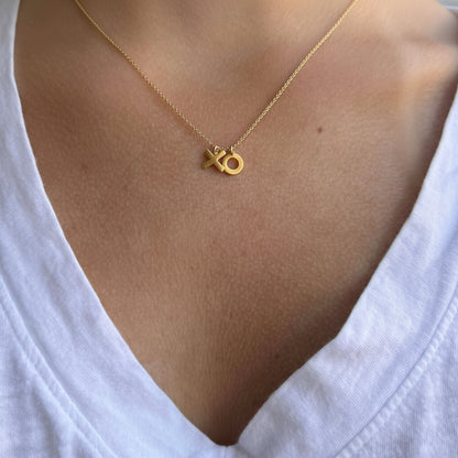 Gold-tone XO charm necklace on short chain