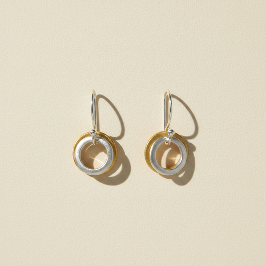Two-tone small hoop earrings with stacked circle charms, gold and silver rings