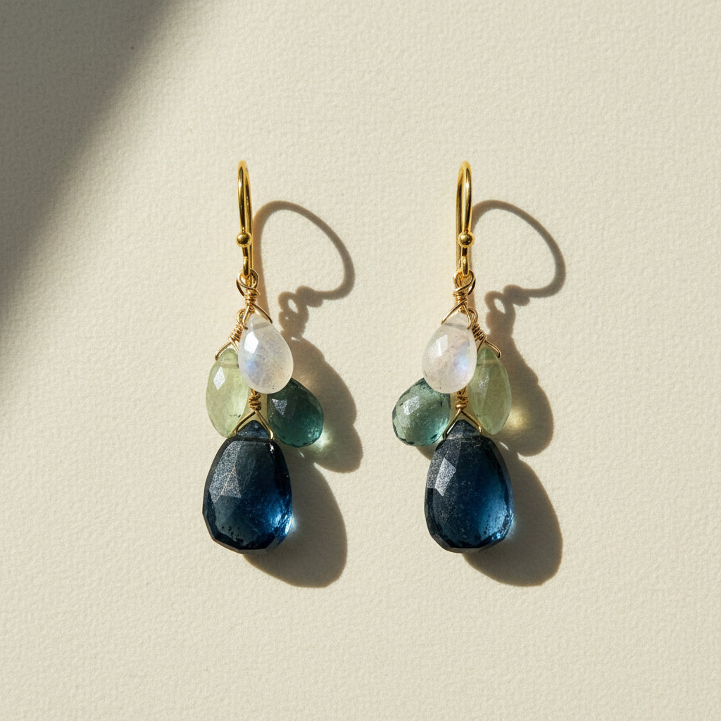 Cluster drop earrings with gold hooks and layered blue, green, and clear beads