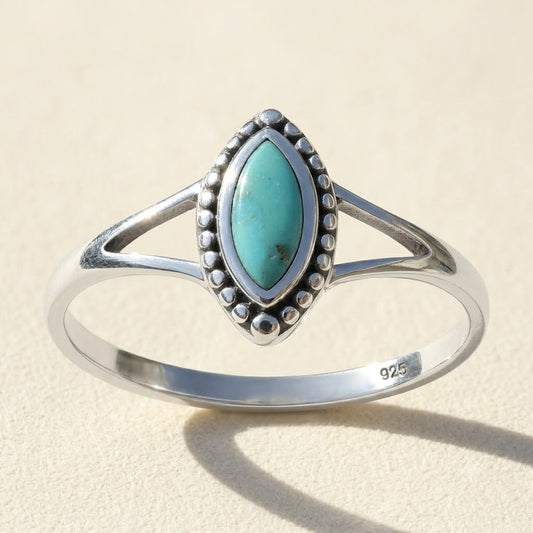 Silver oval turquoise gemstone ring with bezel and beaded border, marked 925