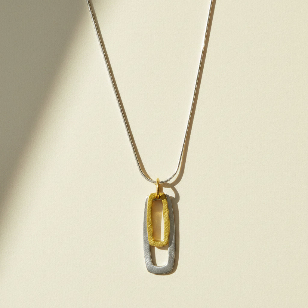 Two-tone rectangular pendant necklace: gold and silver double rectangle links