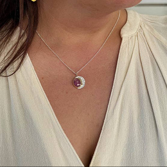 Silver chain necklace with round pink gemstone pendant in hammered metal bezel