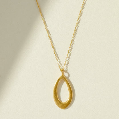 Gold leaf-shaped pendant necklace with slim chain and open teardrop charm
