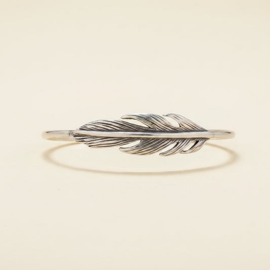 Silver feather-shaped bracelet on a white background
