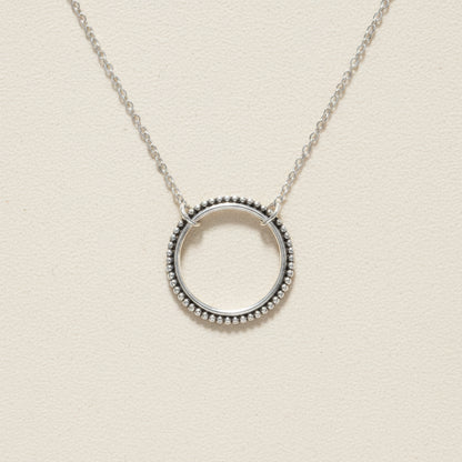 Silver circle pendant necklace with dotted round halo and link chain