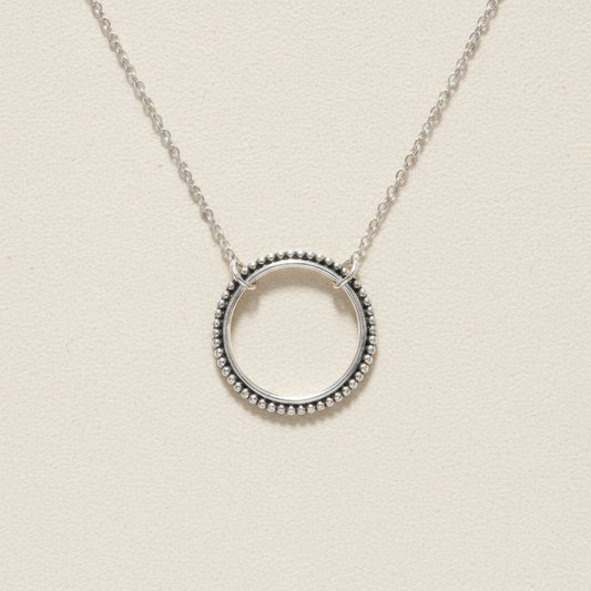 Silver circle pendant necklace with dotted round halo and link chain