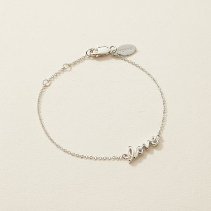 Sterling silver script love bracelet with adjustable clasp and small love charm