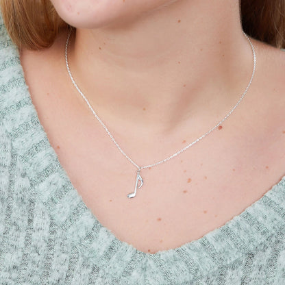 Silver-tone chain necklace with quarter note pendant at collar