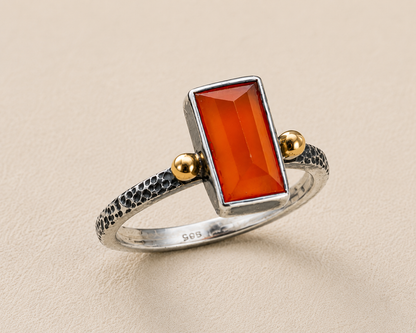 Carnelian orange rectangular stone ring, silver textured band, gold bezel side knobs