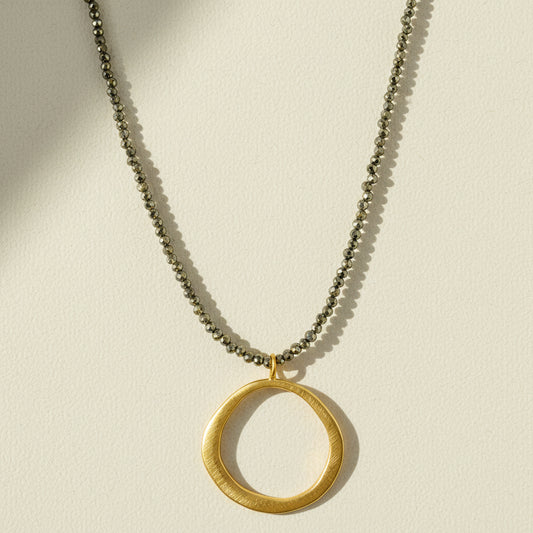 Gold open-circle pendant necklace with short chain and circular charm at center