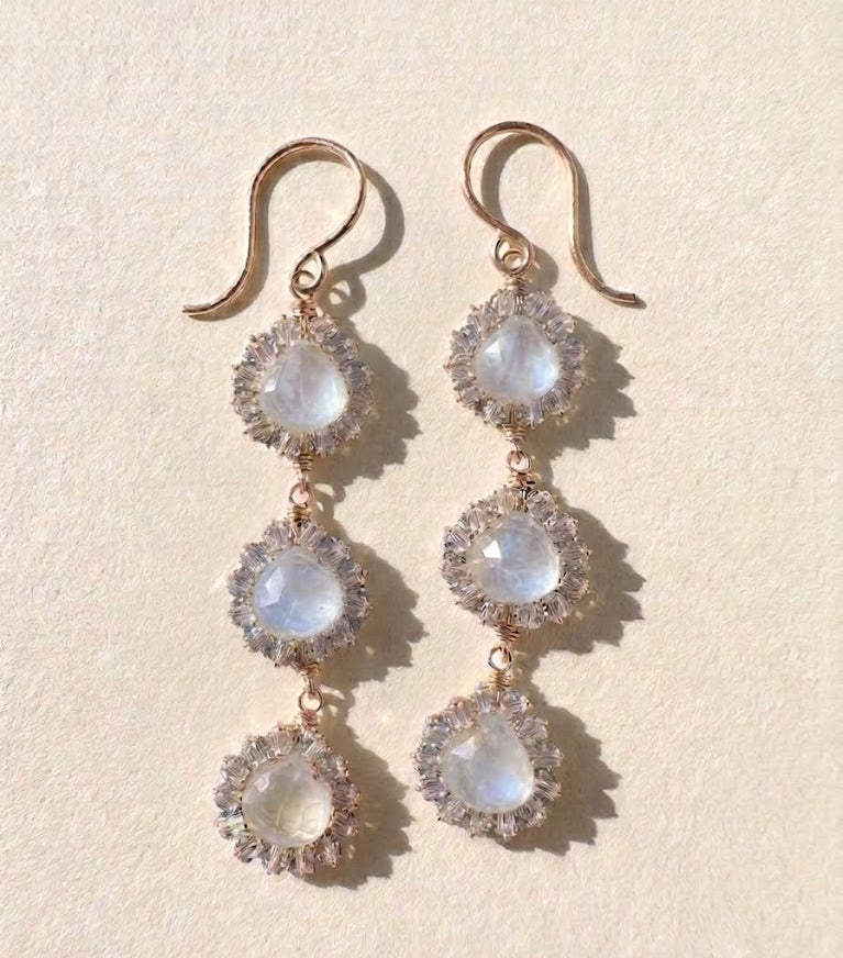 Silver-tone drop earrings with three faceted opal-like stones in crystal halos