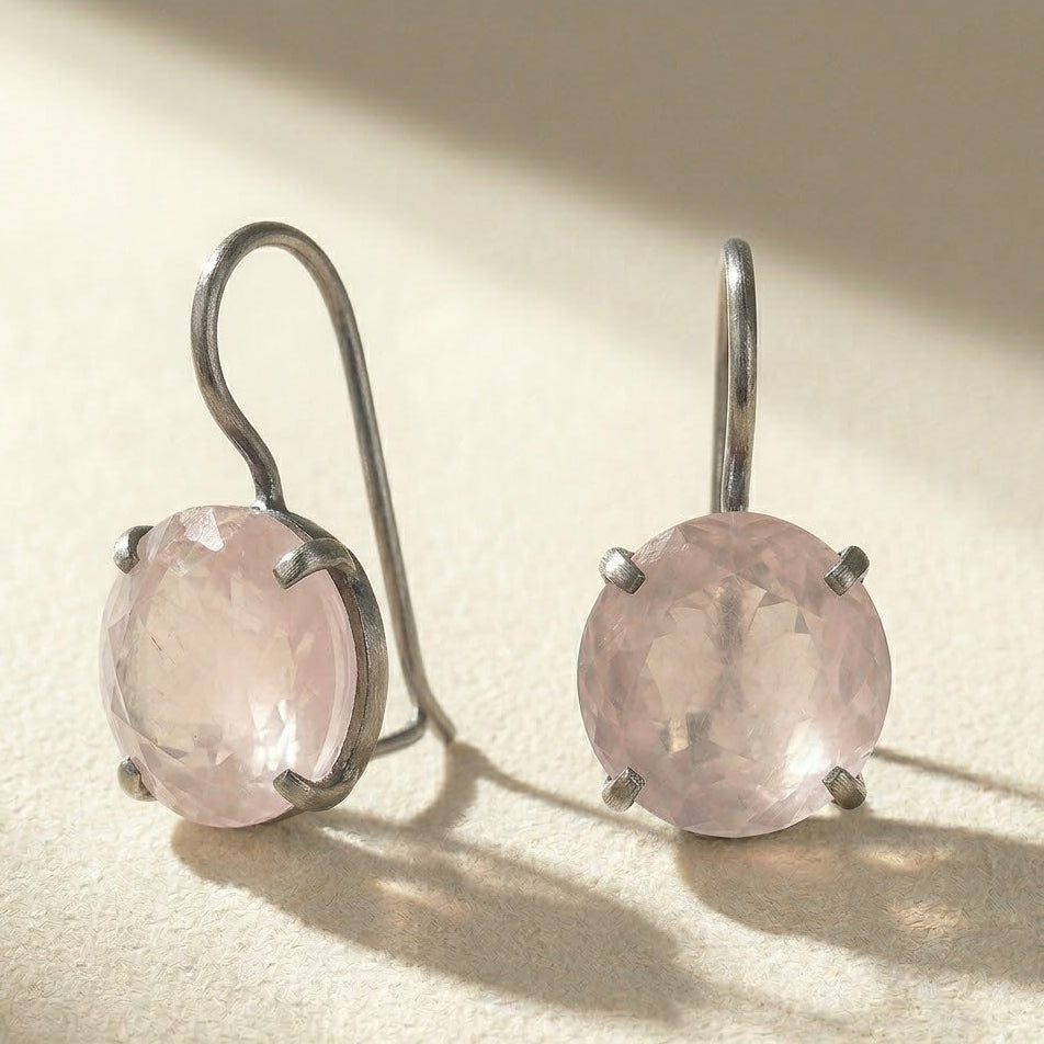 Silver-tone drop earrings with round faceted pale pink stone in prong setting