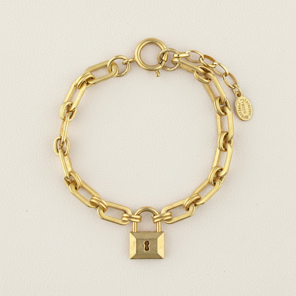 Gold-tone chain bracelet with padlock charm and round toggle clasp