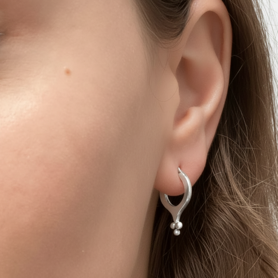 Silver hoop earrings with small ball granulation cluster at the bottom