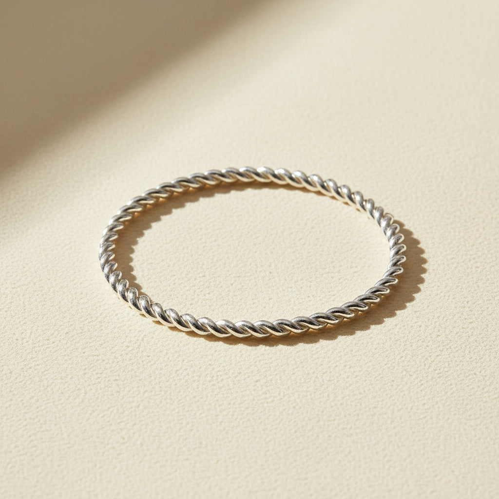 Twisted metal band ring with rope-like cable twist, silver-toned