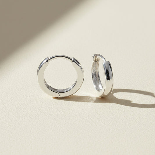 Tiny silver-tone huggie hoop earrings, hinged clasp
