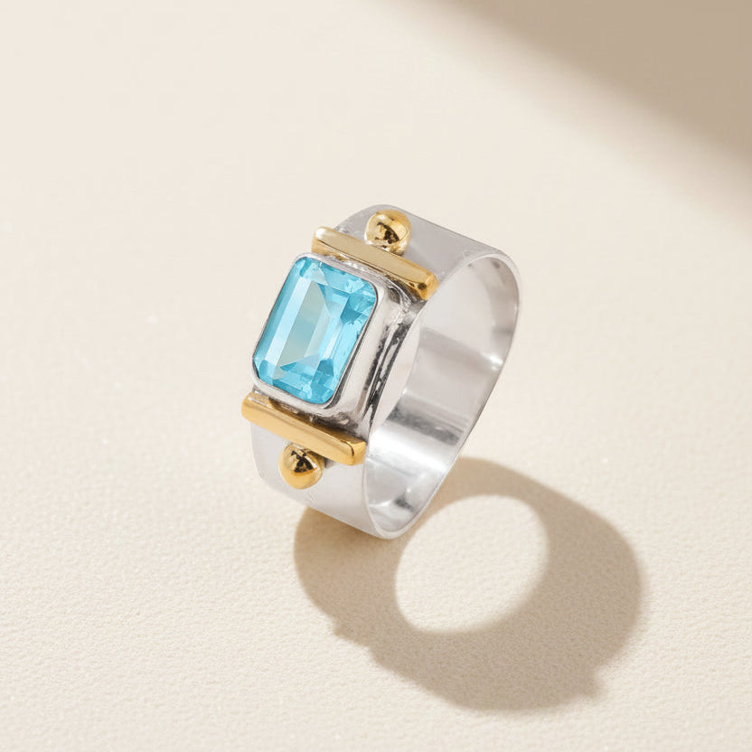 Wide band ring with square sky-blue Topaz-style gemstone in gold bezel