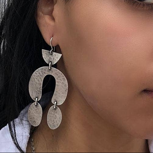 Hammered metal drop earrings with three overlapping curved plates and small hooks