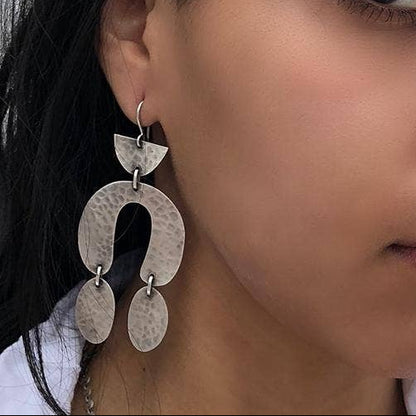 Hammered metal drop earrings with three overlapping curved plates and small hooks