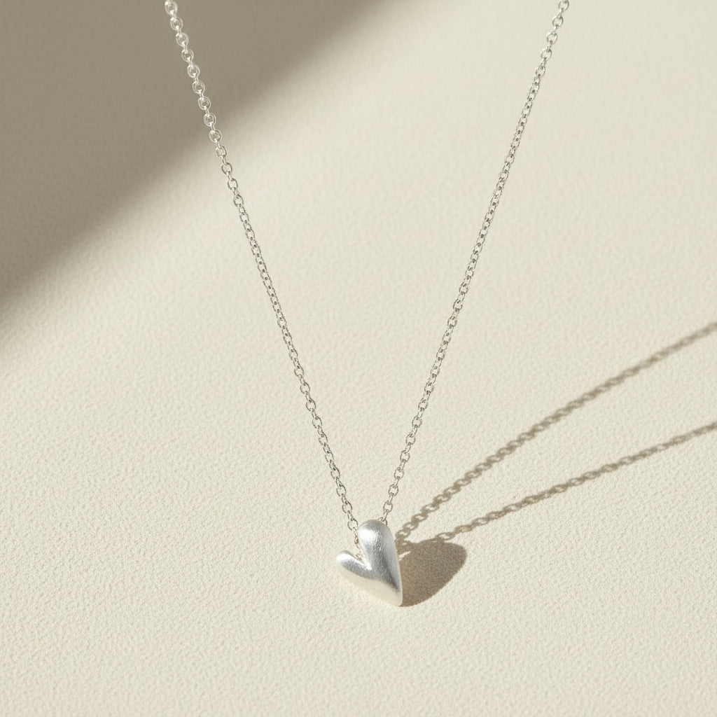 Heart pendant necklace with small polished silver heart charm on chain