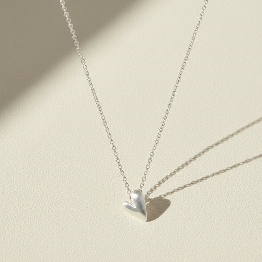 Heart pendant necklace with small polished silver heart charm on chain