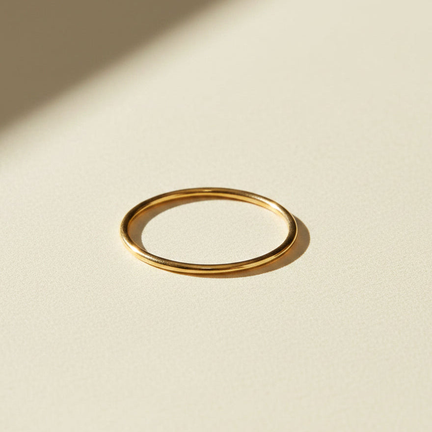 Thin gold stacking ring with smooth band, oval top view