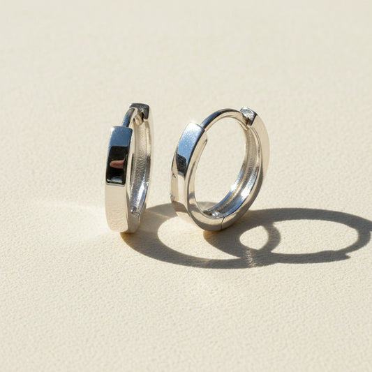 Narrow huggie hoop earrings, silver-tone metal with glossy inner hinge