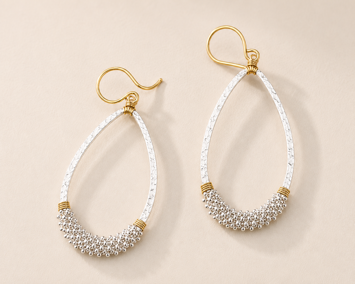 Two-tone silver beaded teardrop earrings with gold-tone hooks and hammered top.