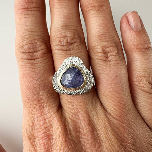 Silver ring with oval dark purple gemstone and textured swirl setting