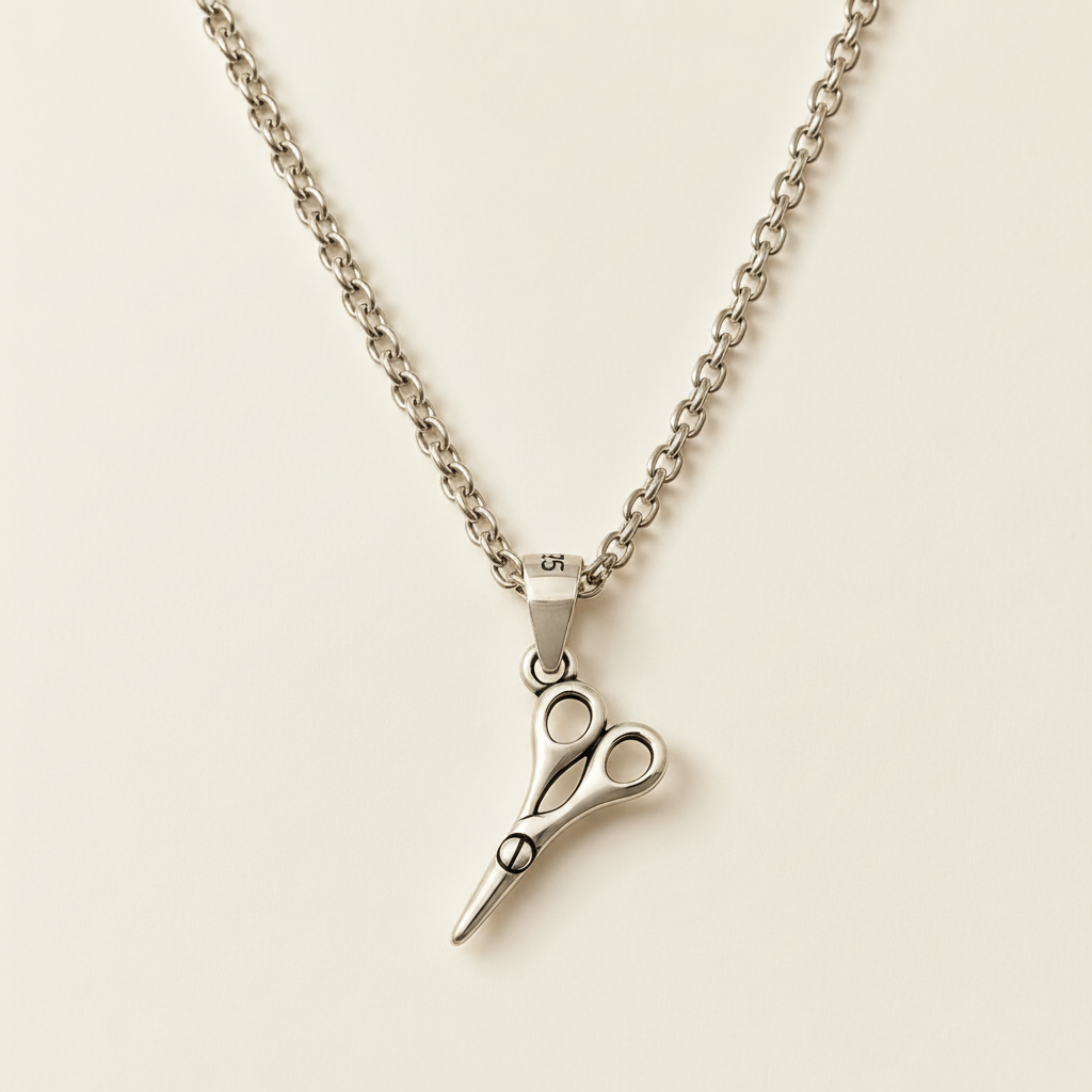 Silver pendant necklace with scissors-style charm and cable chain