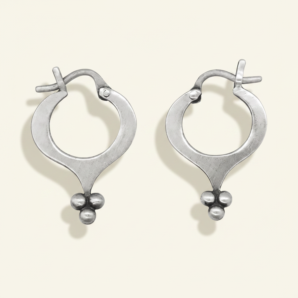 Silver hoop earrings with teardrop silhouette and ball granulation cluster