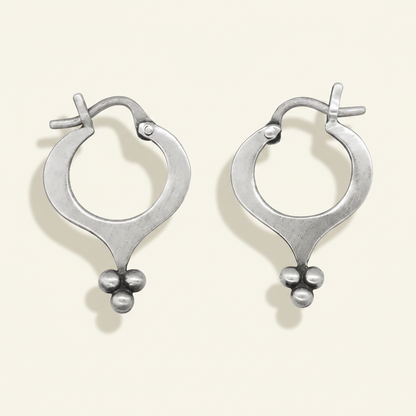Silver hoop earrings with teardrop silhouette and ball granulation cluster
