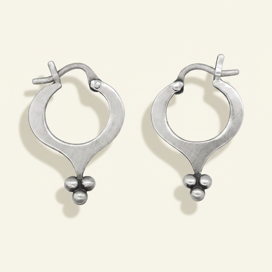 Silver hoop earrings with teardrop silhouette and ball granulation cluster