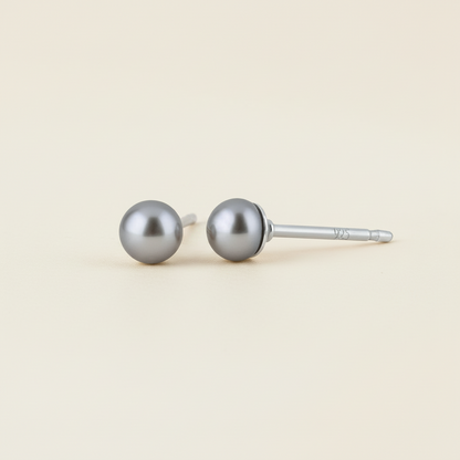 Gray pearl stud earrings with round pearl tops and metal post backs