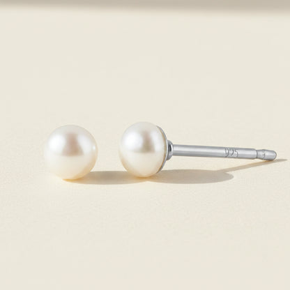Pair of pearl stud earrings on a white background