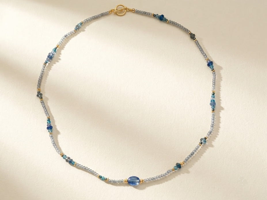 Blue and silver beaded choker necklace with gold clasp and small round teal beads
