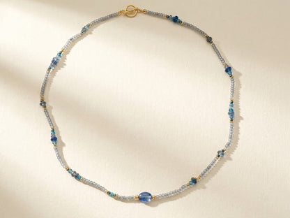 Blue and silver beaded choker necklace with gold clasp and small round teal beads