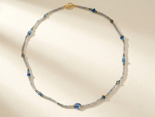 Blue and silver beaded choker necklace with gold clasp and small round teal beads