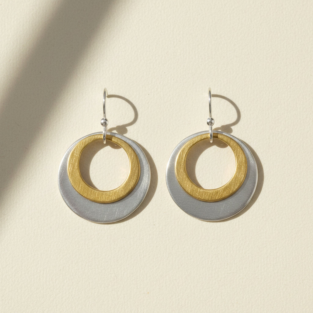 Two-tone double circle earrings with gold inner ring and silver outer disc