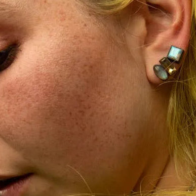 Green chrysoprase oval and baguette stud earrings in black-tone bezel, shown on ear