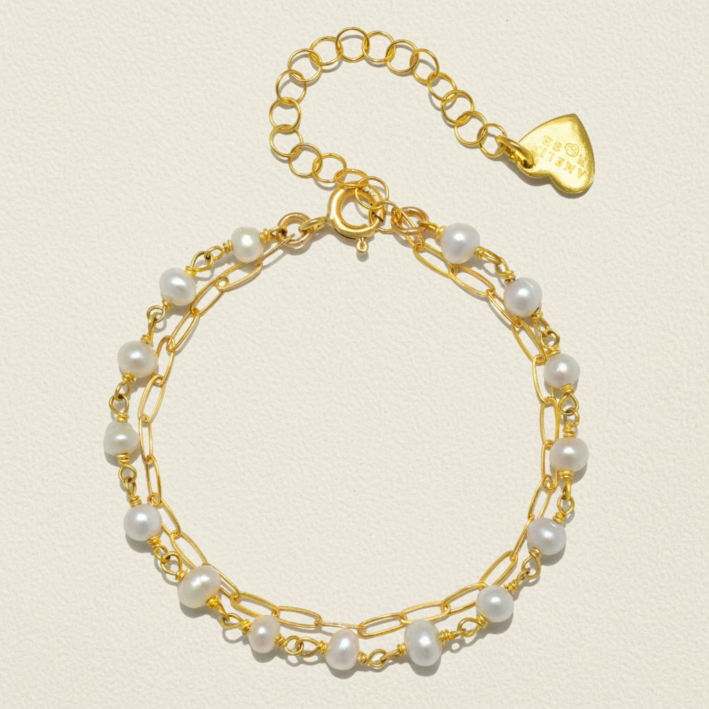 Gold-tone paperclip bracelet with white pearl beads and teardrop charm