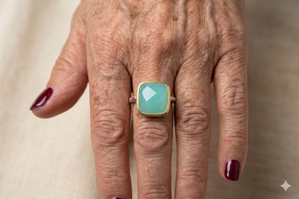 Large square bezel ring with faceted teal semi-precious stone on gold-tone band