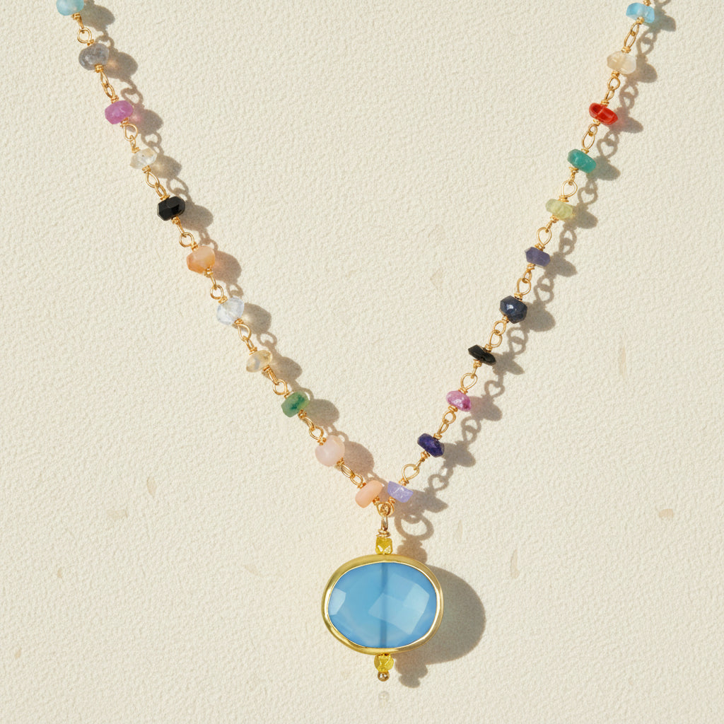 Chalcedony bezel charm necklace with oval blue pendant on multicolor beaded chain