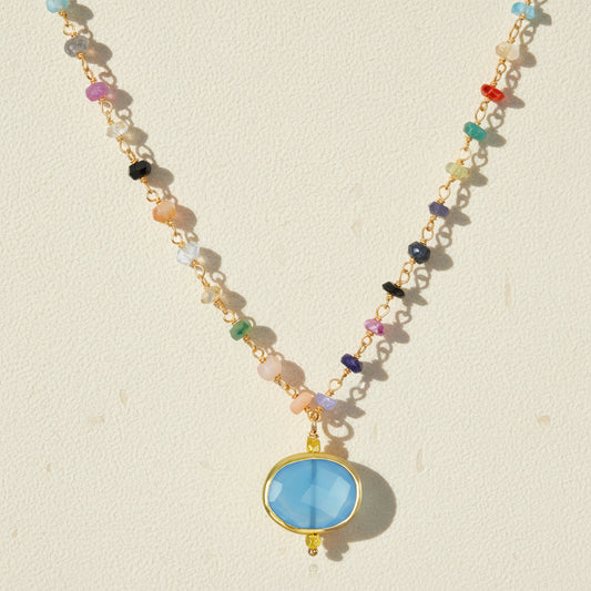 Chalcedony bezel charm necklace with oval blue pendant on multicolor beaded chain