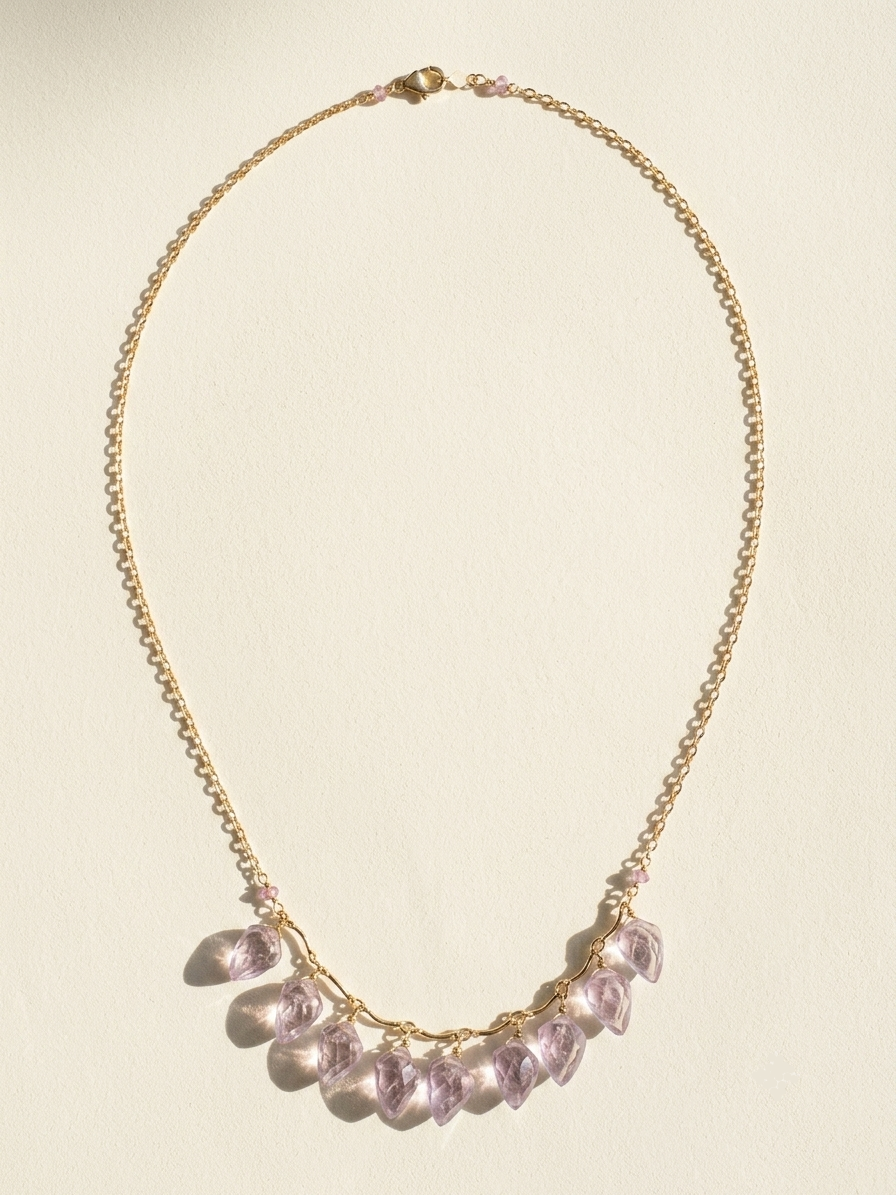 Gold-tone necklace with lilac petal charms on a fine chain