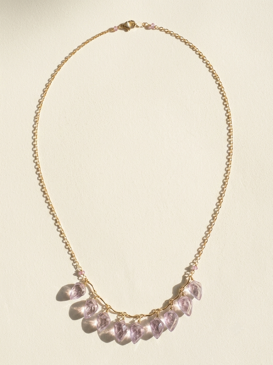 Gold-tone necklace with lilac petal charms on a fine chain