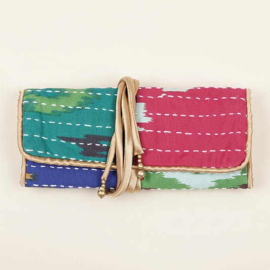 Colorful fabric clutch with a gold strap on a white background