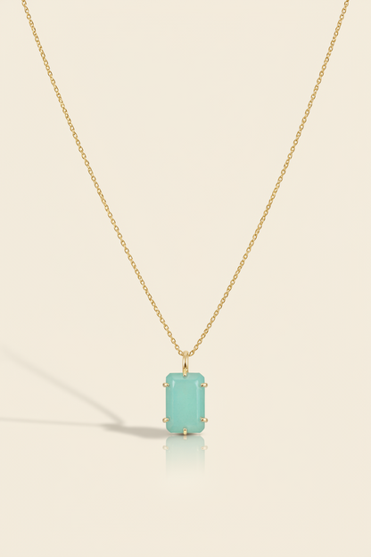 Aqua blue emerald-cut pendant necklace with gold-tone chain and bezel-set stone