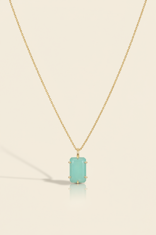 Aqua blue emerald-cut pendant necklace with gold-tone chain and bezel-set stone